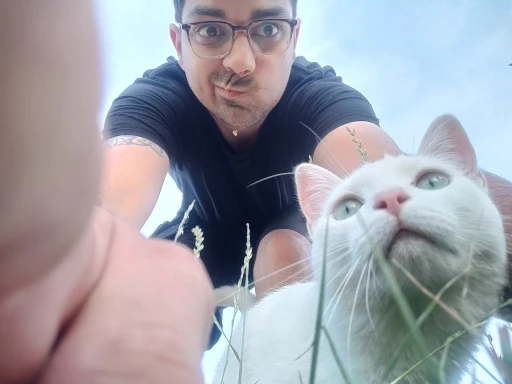 Barthy and his white Maine-Coon and European Short-hair cat named Mew